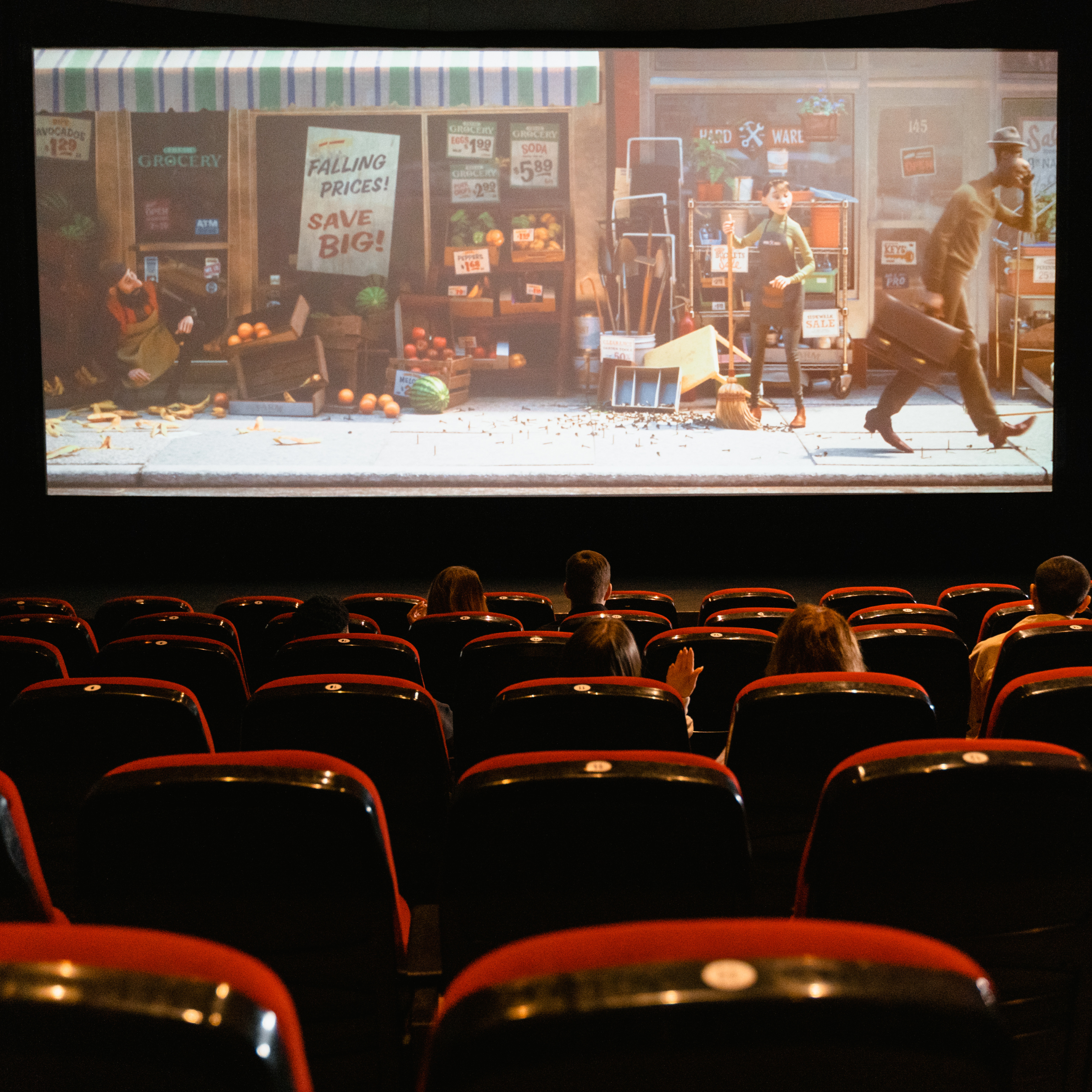 Audience inside an auditorium  watching an animated film.